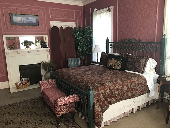Heritage Room bed and fireplace